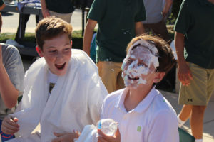 ACDS advisory two male students laughing at pie in face on one student
