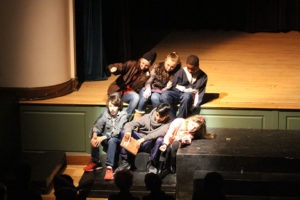 ACDS arts six students siting on steps on stage