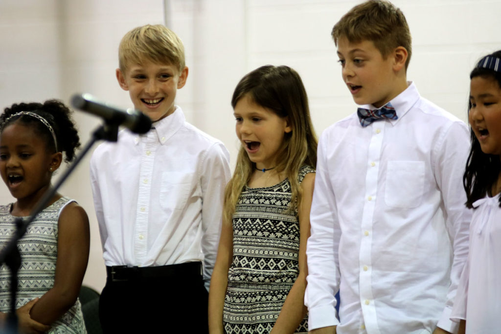 ACDS music five students singing on stage