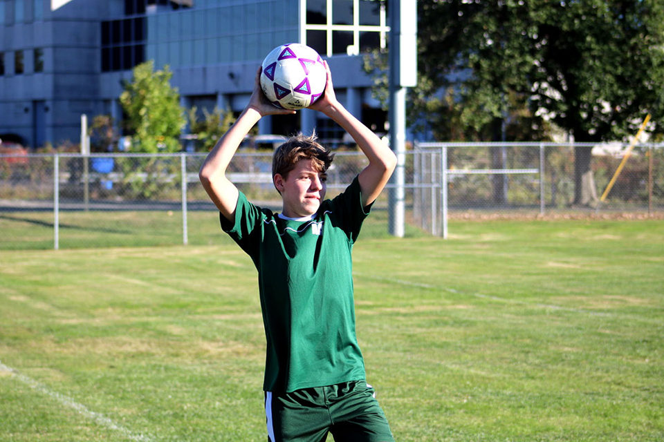 ACDS athletics male student tossing soccer ball