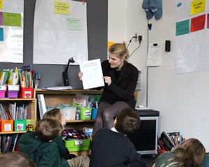 Faculty Hellmuth reading to students