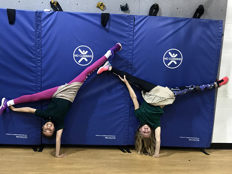 ACDS Middle School two girls in gym doing cartwheels
